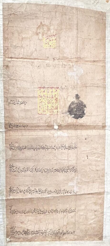 "The historic Mughal Farman issued by Shah Alam II in 1773, written in Persian Shikasta script, preserved in the Telangana State Archives, promoting religious tolerance for Ganga River pilgrims."