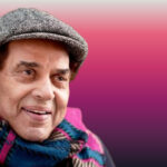 Smiling portrait of veteran Bollywood actor Dharmendra wearing a cap and scarf, featured by Shah Times