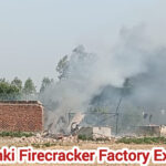 Firefighters and police at Barabanki firecracker blast site amid smoke and debris.